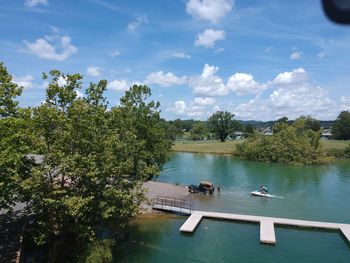 High angle view of river amidst trees against sky