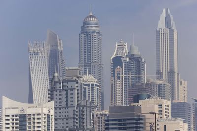 Skyscrapers in city against sky