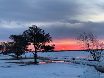 Scenic view of lake against sky during winter