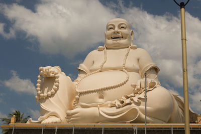 Low angle view of statue against temple against sky