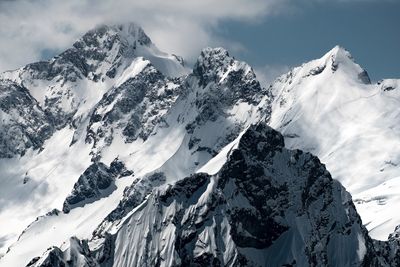 Panoramic view of snowcapped mountains against sky