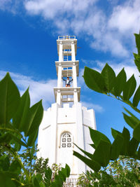 Low angle view of tower amidst buildings against sky