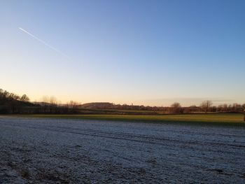 Scenic view of field against clear blue sky