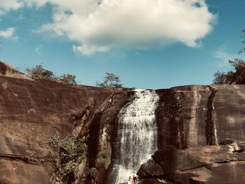 Low angle view of rock formation against sky