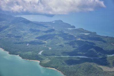 Scenic view of sea and mountains against sky