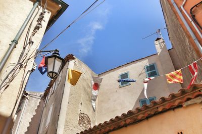 Low angle view of flags hanging in city