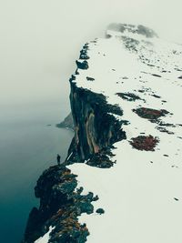 High angle view of rock formation in sea against sky