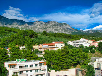 Townscape by mountains against sky