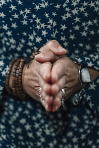 Midsection of woman with hands clasped