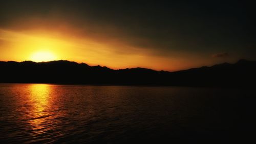 Scenic view of lake against sky during sunset