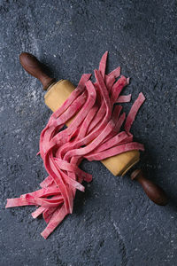 High angle view of red chili pepper on wood