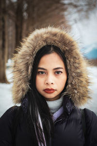 Portrait of a young woman wearing winter jacket