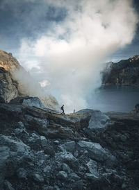 Scenic view of rocks and mountains against sky