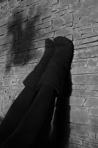 Low section of person with shadow on wall