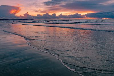 Scenic view of beach against sky during sunset