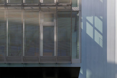 Modern building against sky seen through glass window