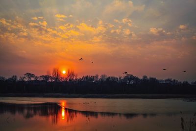 Scenic view of lake against sky during sunset