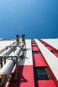 Tilt image of building against clear blue sky