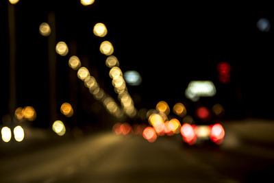 Defocused image of illuminated city at night