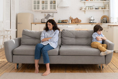 Woman sitting on sofa at home