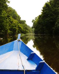 Boat moored in lake against sky