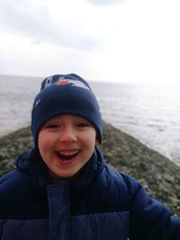 Portrait of smiling boy standing at beach