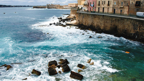 Ortigia siracusa island with waves of sea on the rocks