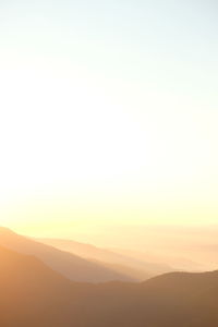 Scenic view of silhouette mountains against sky at sunset