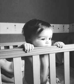Cute boy in crib at home
