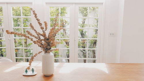 Close-up of white curtain on table at home