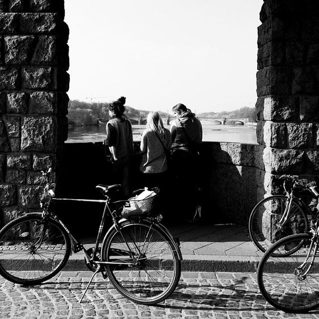 bicycle, transportation, mode of transport, built structure, architecture, land vehicle, clear sky, building exterior, men, lifestyles, leisure activity, stationary, street, person, parked, railing, sunlight, parking, day