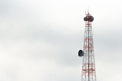 Low angle view of communications tower against sky