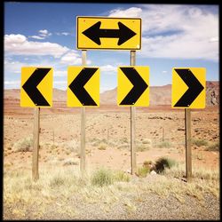 Road sign against sky