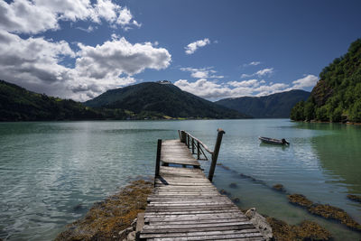 Pier over lake against sky