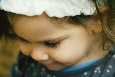 Close-up of cute girl looking down