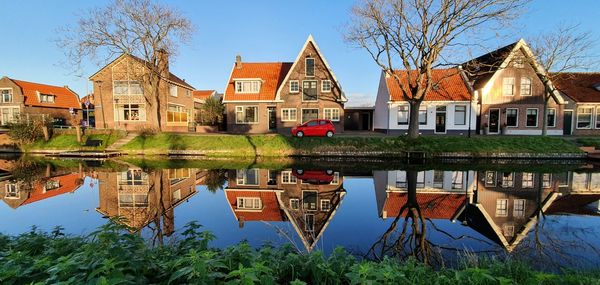 Reflection of building and trees in canal