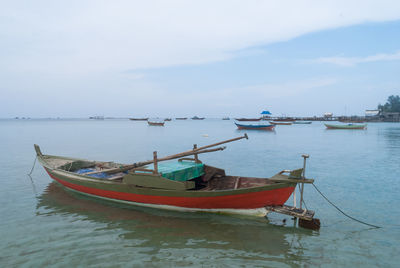 Boats moored in sea