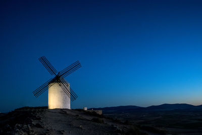 Traditional windmill against clear blue sky