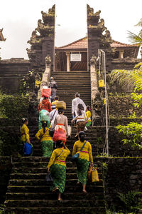 Group of people in traditional building against sky