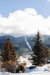 Scenic view of snow covered mountains against sky