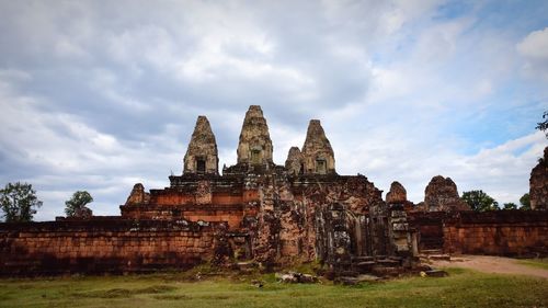 Old temple against cloudy sky