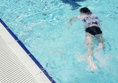 High angle view of woman swimming in pool