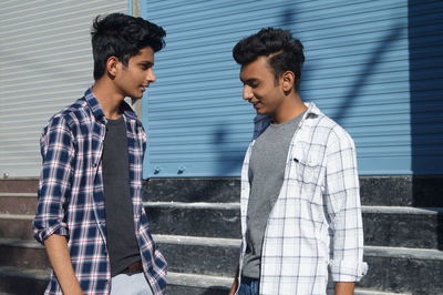 Side view of young man using mobile phone