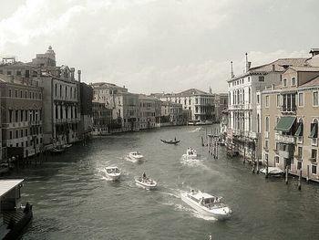 Boats in canal with buildings in background