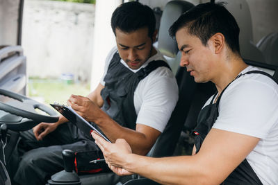 Side view of man using mobile phone