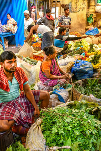 People sitting at market stall