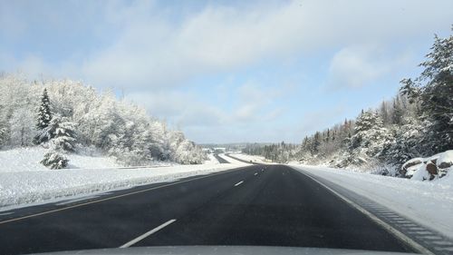 Road seen through car windshield during winter