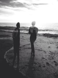 Rear view of people on beach