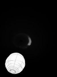 Low angle view of illuminated lantern against clear sky at night