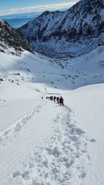 People skiing on snow covered mountain